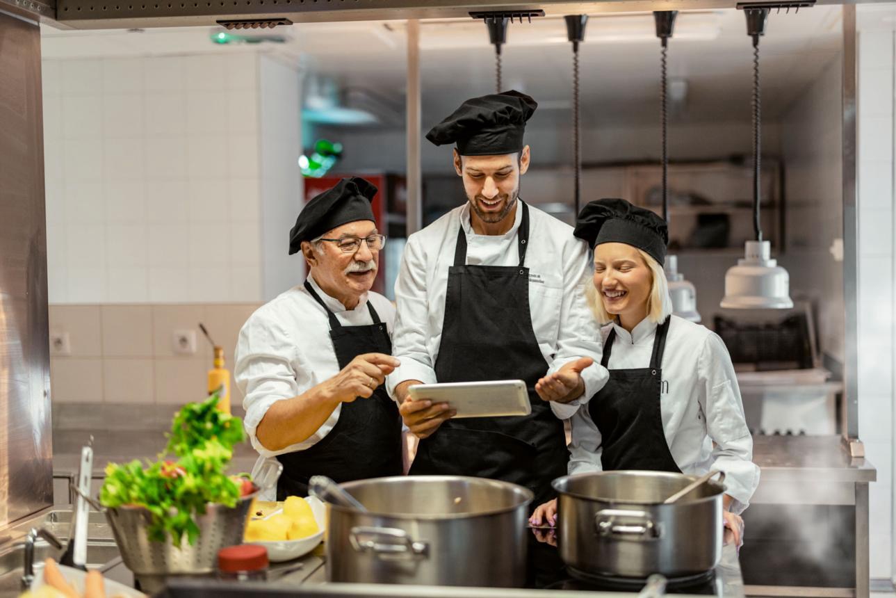 Professional chefs using digital kitchen tools